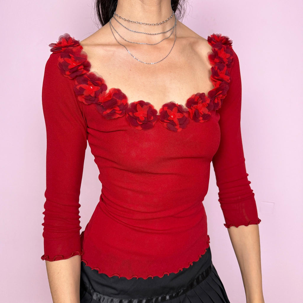 Vintage 2000s Moschino Jeans red mesh top featuring a fitted silhouette, 3/4 sleeves and sculptural floral appliqué trim along the neckline. Designed in a bold red tone with a soft stretchy semi-sheer finish and delicate lettuce-edge hems. A striking Italian designer Y2K piece, perfect for evening styling or elevated statement looks. Made in Italy. Fabric composition unknown due to missing label. Excellent vintage condition.