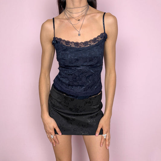 Vintage 2000s romantic Moschino Jeans navy blue lace camisole crafted in delicate floral lace with a softly fitted silhouette and scalloped neckline. Features adjustable straps with rhinestone details, a side zip closure, and sheer layered construction. No stretch. A refined Y2K piece that blends effortless femininity with understated designer appeal. Perfect for summer, party, or evening wear. Made in Italy from a nylon viscose blend. Excellent vintage condition.