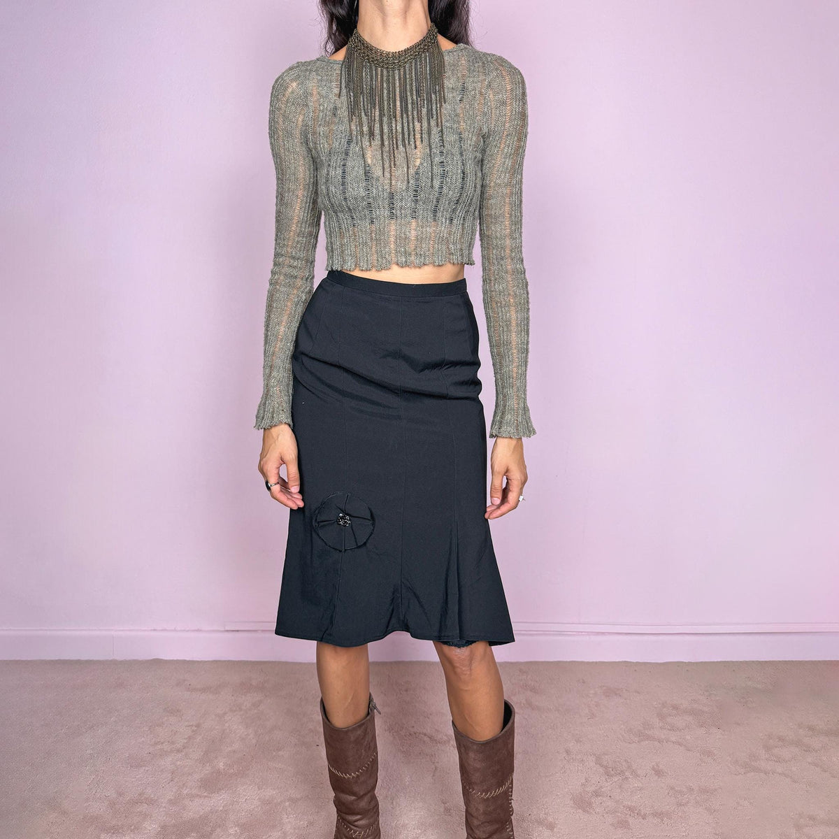 Vintage 2000s black midi skirt by Japanese designer Ritsuko Shirahama. Features a high-waisted, fitted silhouette with clean vertical seam construction, a softly flared hem, and a sculptural circular appliqué near the lower front. Finished with a back zip closure. Made in Japan from a non-stretch blend of 78% silk and 22% polyurethane, with a 100% polyester lining. Great vintage condition.