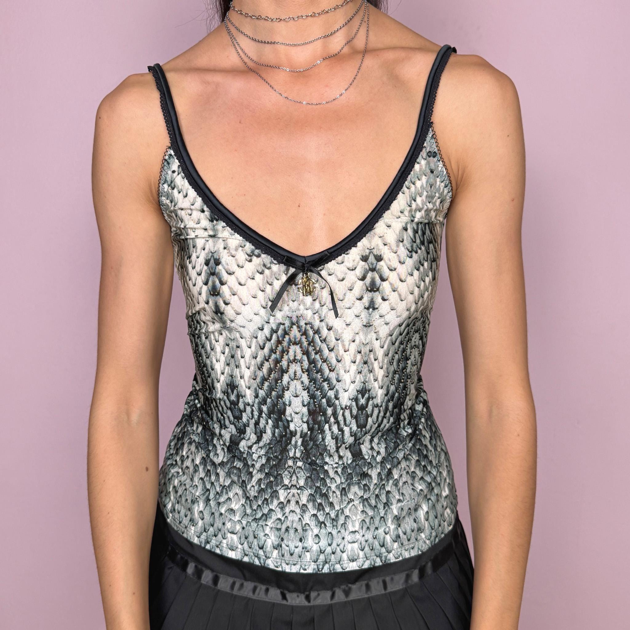Vintage 2000s Roberto Cavalli Underwear white cami top in a striking black, gray, and greenish snake/reptile print with a fitted stretchy silhouette, black trims, and a delicate front bow detail with a gold-tone Cavalli charm. Made in Italy from a 75% polyamide and 25% elastane blend, with a flattering deep V neckline and thin straps. A sensual Y2K piece for lingerie-as-outerwear looks. Excellent vintage condition.
