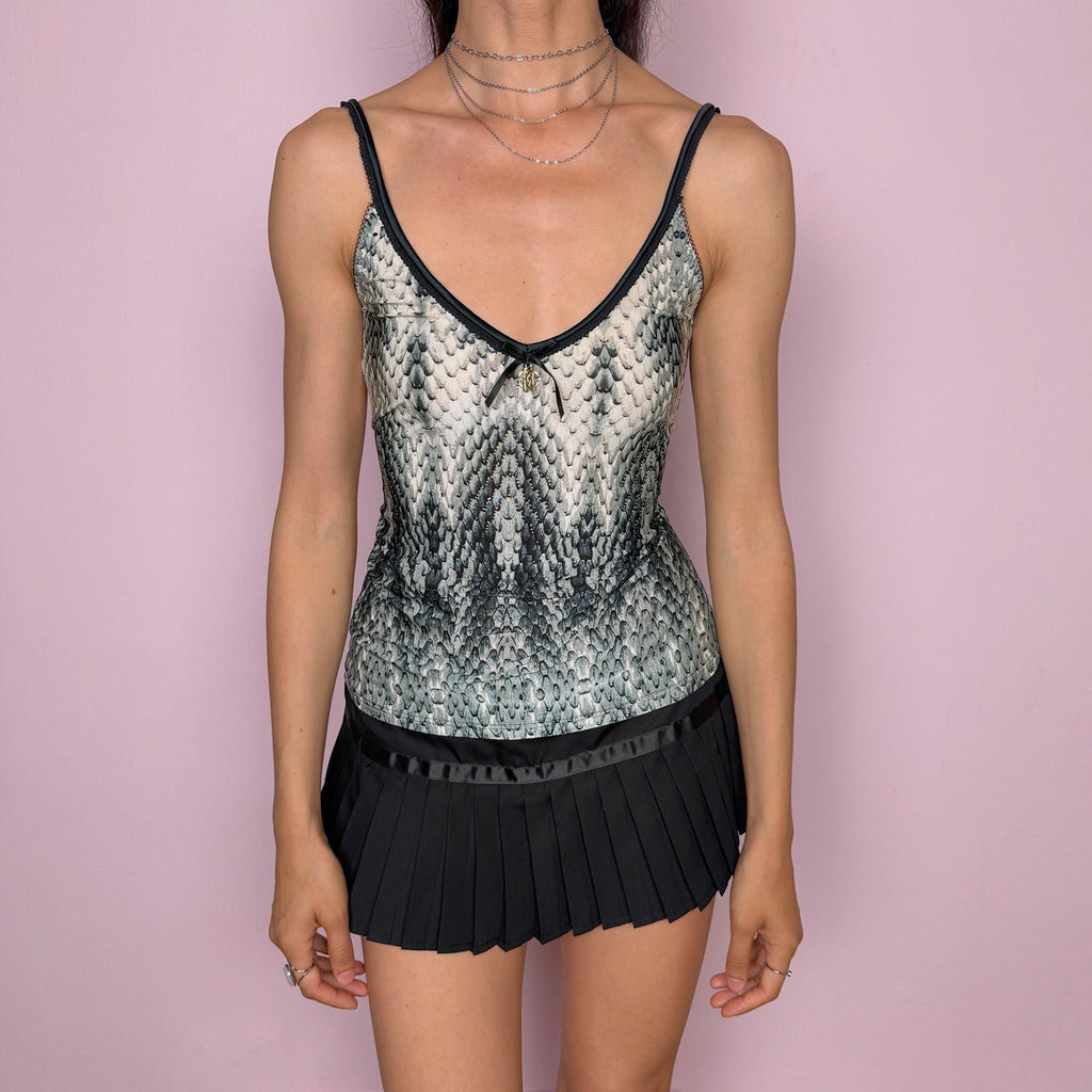 Vintage 2000s Roberto Cavalli Underwear white cami top in a striking black, gray, and greenish snake/reptile print with a fitted stretchy silhouette, black trims, and a delicate front bow detail with a gold-tone Cavalli charm. Made in Italy from a 75% polyamide and 25% elastane blend, with a flattering deep V neckline and thin straps. A sensual Y2K piece for lingerie-as-outerwear looks. Excellent vintage condition.