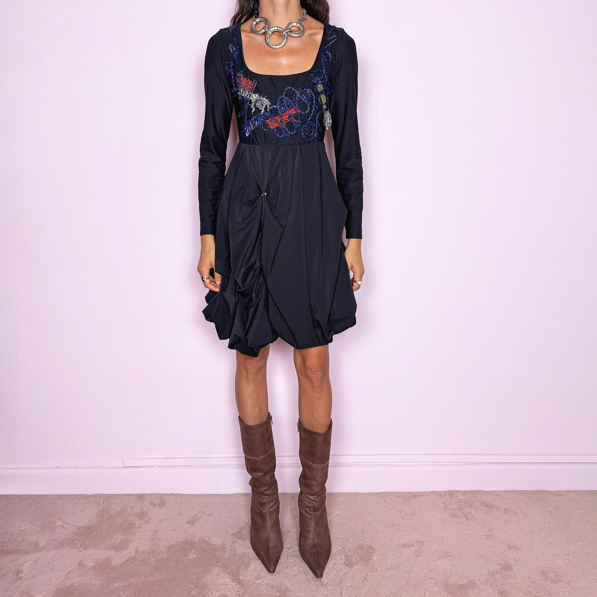 Vintage 2000s black long-sleeve mini dress by Italian label Save the Queen, made in Italy. Featuring a fitted stretchy bodice with a scoop neckline, layered textile appliqué detailing across the chest, and a sculptural draped bubble skirt with gathered volume and asymmetric folds. The sleek bodice and exaggerated balloon silhouette create an avant-garde, deconstructed look. Composition label is missing, so the exact fabric is unknown. Excellent vintage condition.