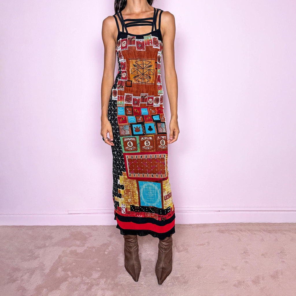 Vintage 2000s Save the Queen maxi dress, made in Italy from stretchy 100% polyamide mesh with a black mesh lining. Featuring an intricate multicolored graphic print with abstract symbols, game-inspired motifs, and richly layered artwork throughout, framed by strappy black mesh detailing across the neckline and shoulders. The long, fitted silhouette and highly detailed print give it a distinctive maximalist, art-to-wear feel characteristic of Y2K Italian fashion.