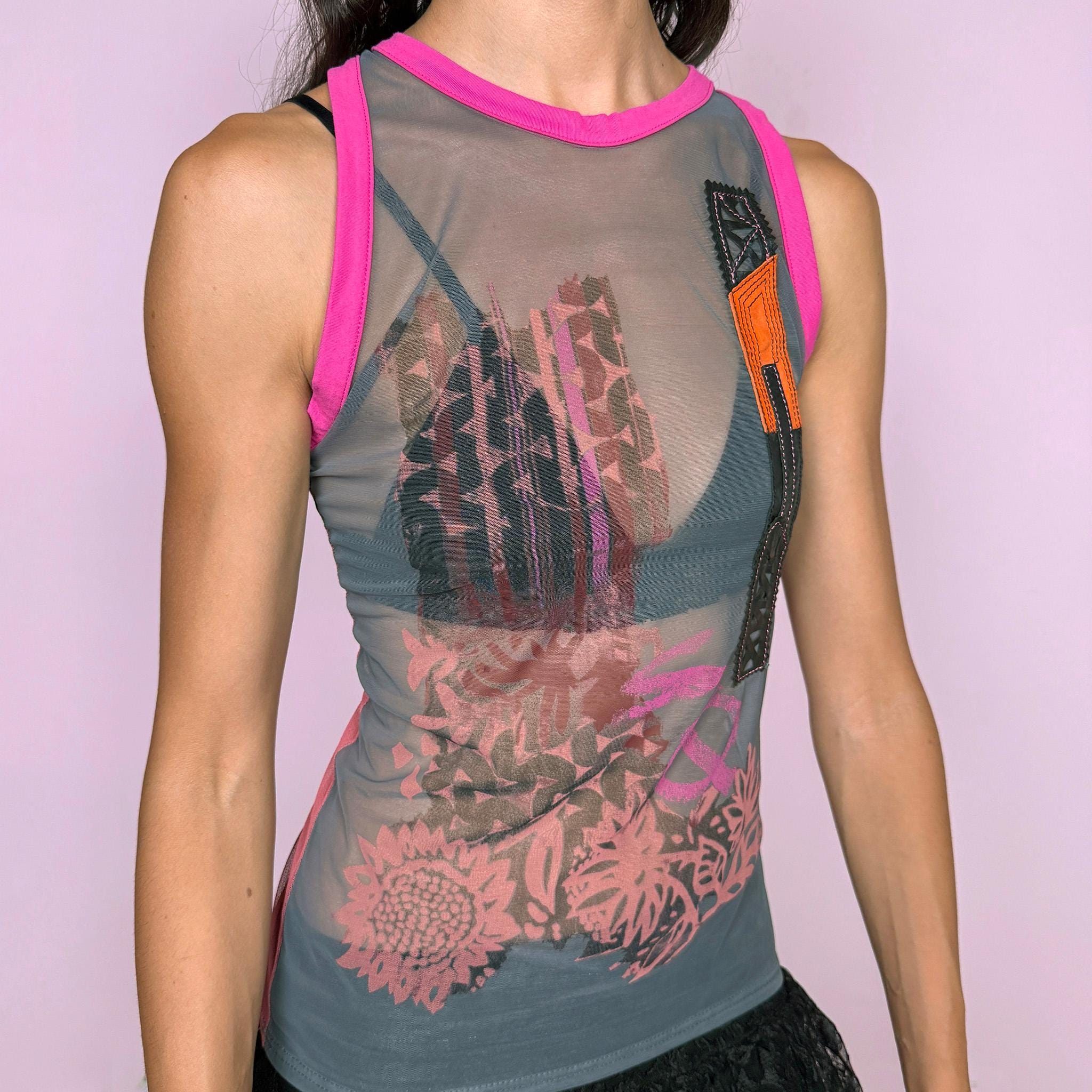 Vintage 2000s Save the Queen sleeveless sheer mesh top featuring an eclectic mixed graphic print in gray with vivid fuchsia contrast trim, intricate embroidery, and genuine leather appliqué inserts across the front, plus textured geometric detailing throughout the back. Perfect for bold, deconstructed summer outfits. Made in Italy from 100% polyamide with leather inserts. Excellent vintage condition.