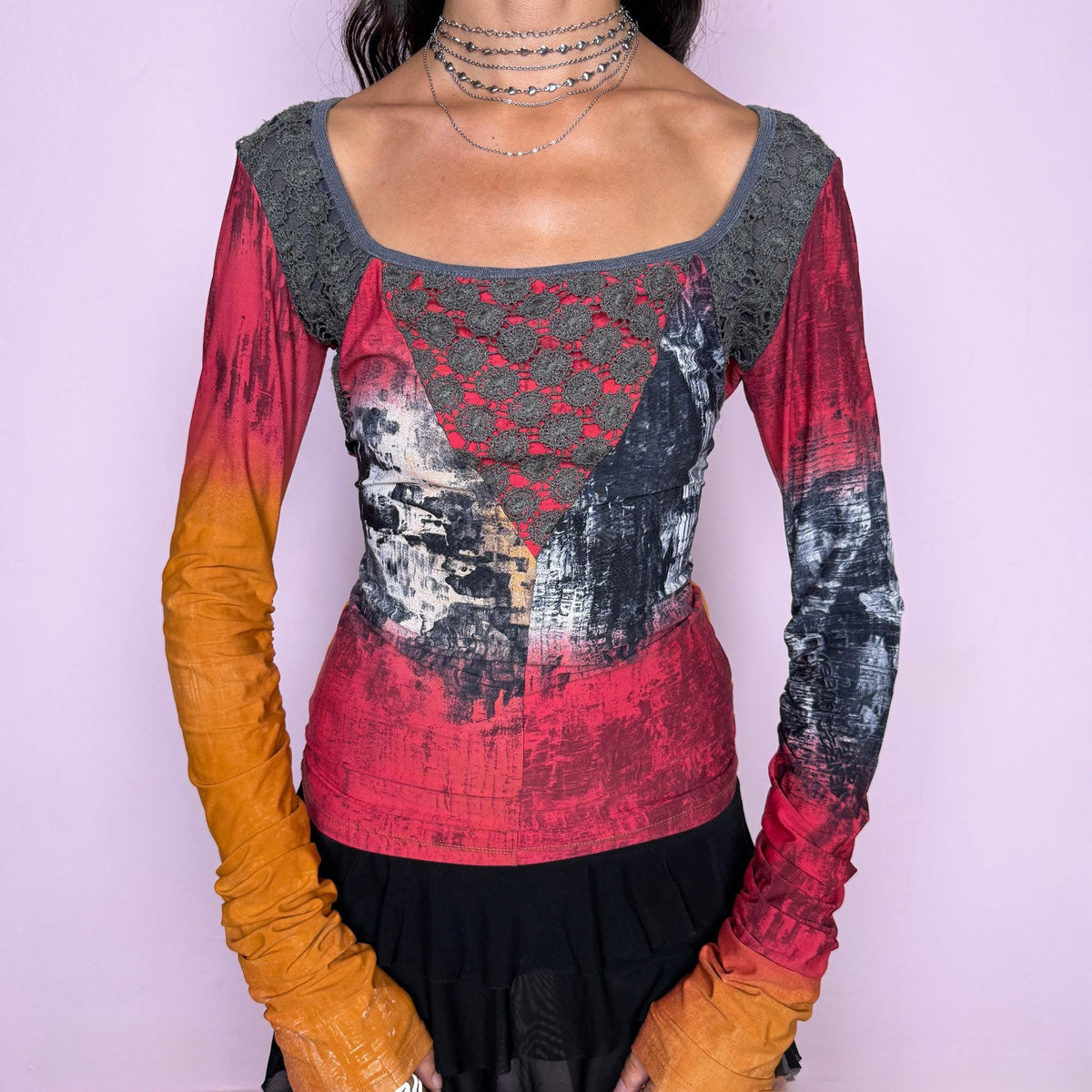 Vintage 2000s long-sleeve top by Italian label Save the Queen, featuring a fitted, body-skimming silhouette, scoop neckline, contrasting lace paneling across the upper bodice, and an abstract painterly print in red, orange, charcoal, and gray tones. Designed with extra-long ruched sleeves for a bold, maximalist aesthetic. Made in Italy from a stretchy 80% polyamide and 20% elastane blend. Excellent vintage condition.
