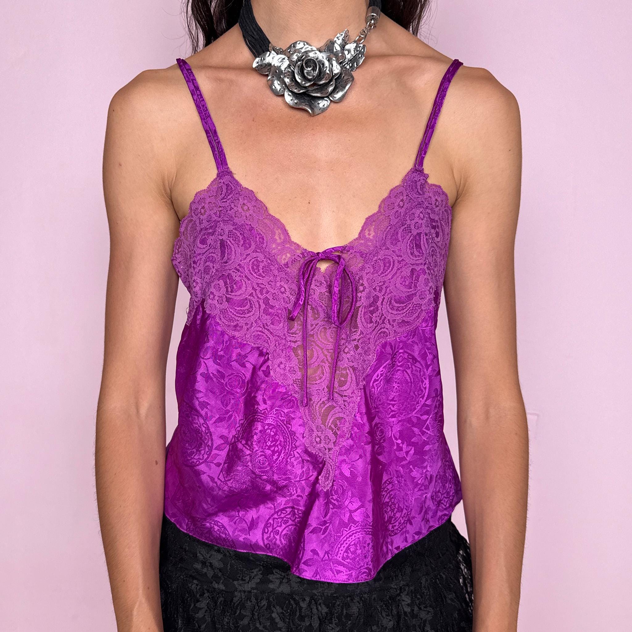 Vintage 2000s romantic Victoria’s Secret purple satin lingerie cami top with floral lace bust, sheer front lace insert, vivid lilac-purple paisley floral jacquard, adjustable spaghetti straps, and small neckline tie. Lightweight, perfect as a feminine statement piece for evening or summer styling. Composition label is missing, so the exact fabric is unknown. Excellent vintage condition.