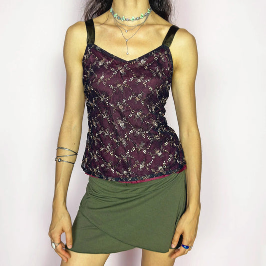 This vintage 90s whimsical burgundy corset-style top features delicate beige-bronze floral embroidery on black tulle overlay, framed by thick brown satin straps and a sleek side zipper. Perfect for summer night parties, garden gatherings, or romantic events. A collectible piece with cottagecore charm, Victorian undertones, and a gothic-romantic edge. Excellent vintage condition.