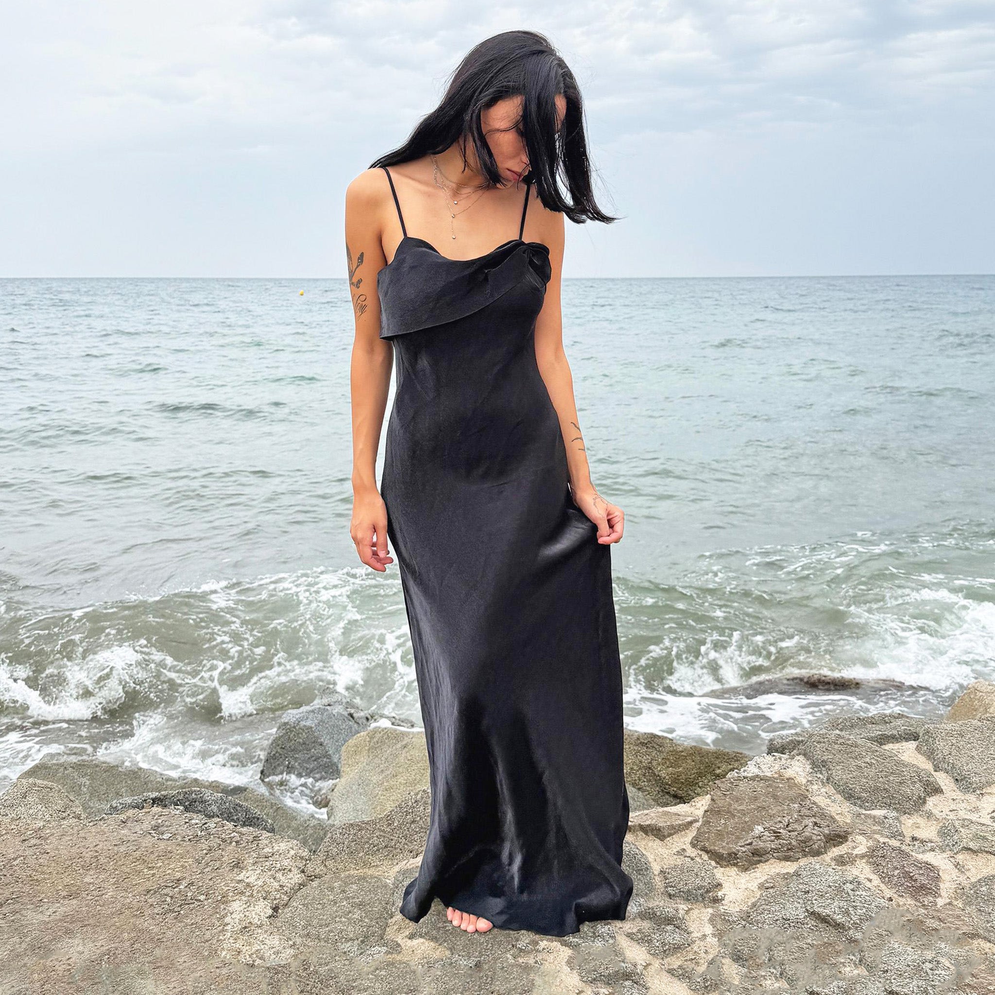 Vintage 90s black slip dress with a straight folded neckline, subtle ruching, fitted silhouette, and sleek maxi length. Finished with a side zipper closure, ideal for evening galas, cocktail parties, or formal occasions with a dark romance feel. Made from non-stretch fabric with a soft sheen. Great vintage condition.