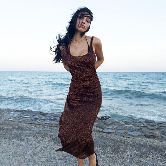 The vintage 90s black midi dress is crafted from sheer devoré velvet with a wild abstract pattern in brown. Sleeveless and fluid, its semi-transparent texture evokes sensual rebellion—ideal for late summer parties, rooftop scenes, or dusk dance floors. A 90s archive dress that blends sensuality and minimalism. Made from a soft, stretchy burnout velvet polyester blend. Great vintage condition.