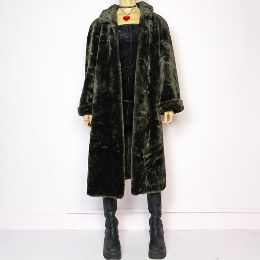 The Vintage 90s Brown Faux Fur Maxi Coat is a luxurious and warm winter essential. This long coat features a plush faux fur design in a deep brown hue, a wide collar and a pullover front closure. Its full length make it perfect for cozy and elegant winter outfits. A statement coat that embodies 90s glamour with timeless appeal. Made from a polyester faux fur blend. Excellent vintage condition.