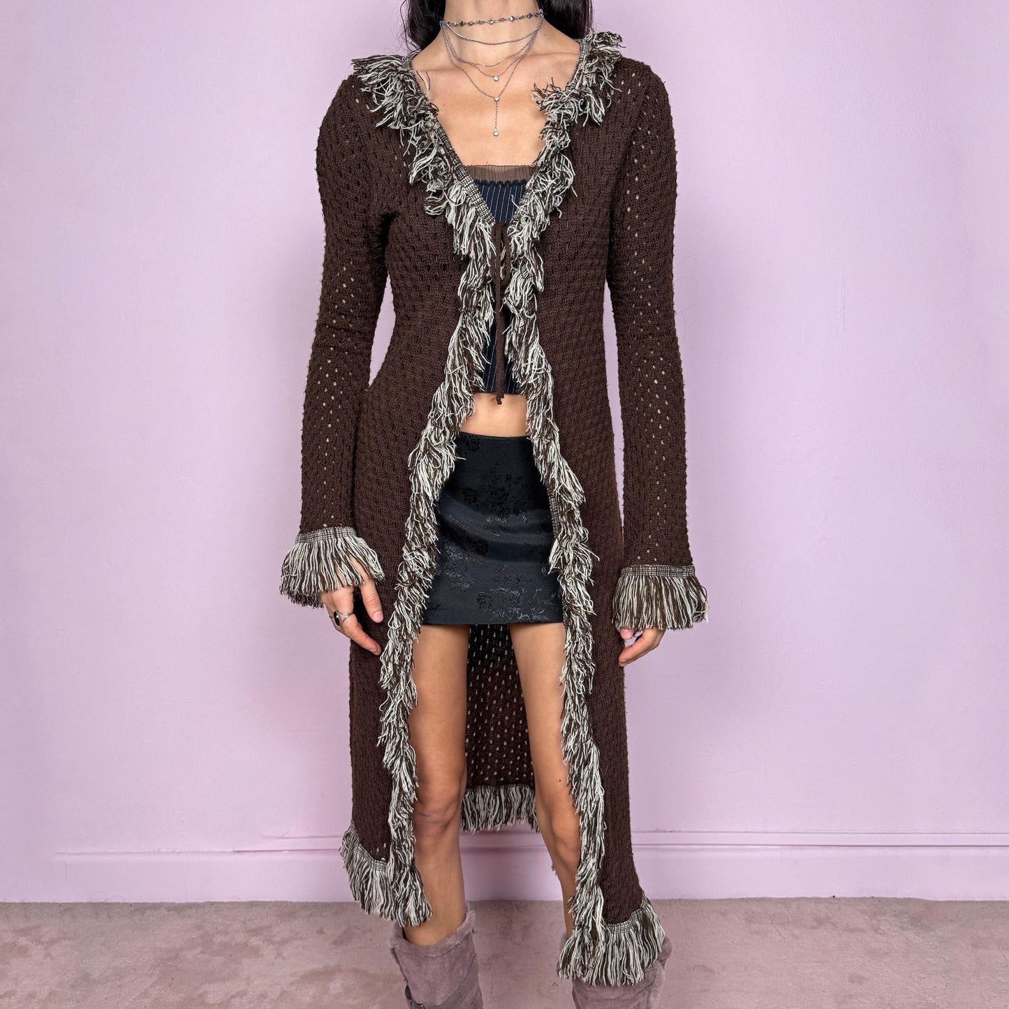 Vintage 90s brown longline cardigan with open knit semi-sheer construction and tie front closure. Features shaggy beige and brown trim along the neckline, cuffs, and hem, with long sleeves and a stretchy comfy fit. Ideal for boho fairycore party looks, festival outfits, or autumn layering. Great vintage condition.