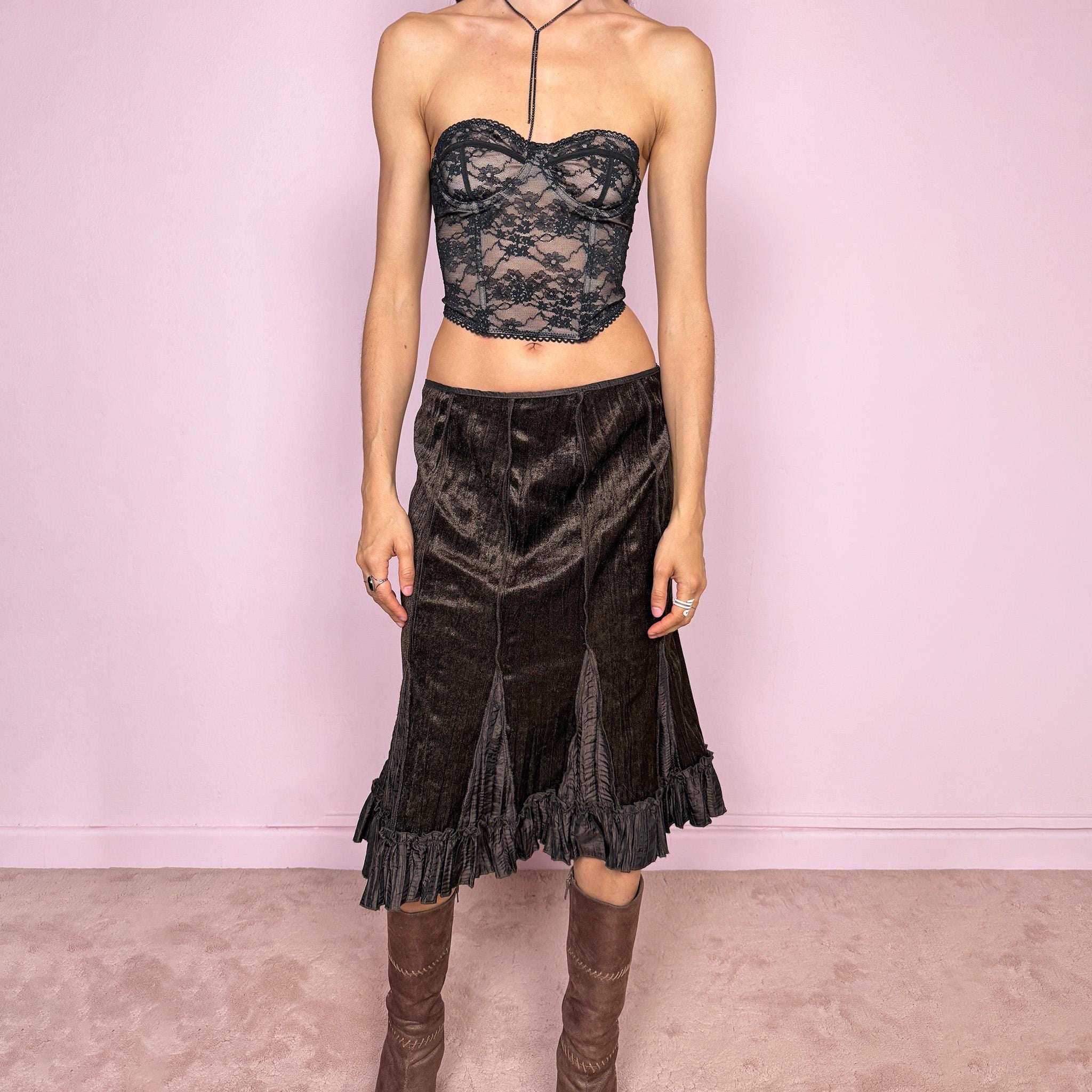 Vintage 90s dark brown velvet midi skirt with a whimsical fairycore feel. Features soft godet inserts creating a flared silhouette and a ruffle hem for movement. Back zip closure with slight stretch. Can be worn high waisted for size L or low rise for size M. Perfect for autumn winter avant garde styling. Great vintage condition.