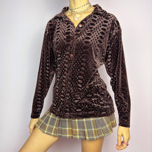 The Vintage 90s Brown Velvet Shirt is a statement piece featuring a unique textured pattern and a button-up front. Crafted from plush velvet in a deep chocolate brown shade, this long-sleeve shirt is perfect for casual autumn outfits. adult world shop