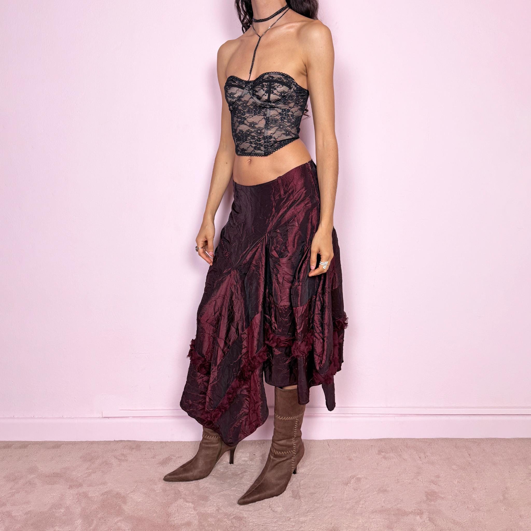 Vintage 2000s burgundy iridescent midi skirt with an avant garde experimental feel. Features a crinkle texture, asymmetric hem, and sculptural draped panels with rosette appliqué details. Voluminous and artistic silhouette with back zip closure, no stretch. Can be worn high waisted for size M or lower for XS/S. Made from polyester. Rare archive piece. Excellent vintage condition.