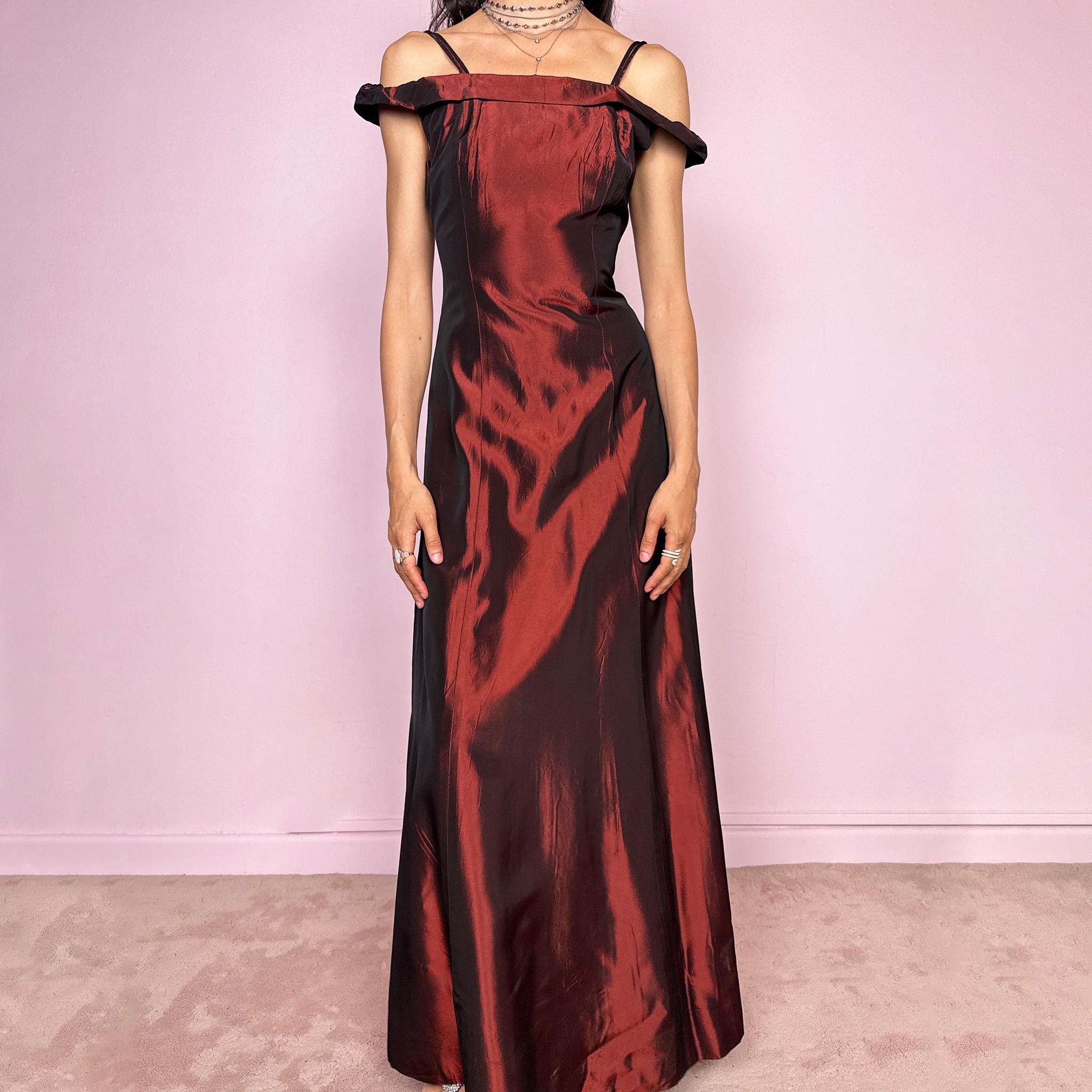 Vintage 2000s statement evening gown in rich burgundy iridescent fabric with a sculpted off shoulder neckline and delicate straps. Elegant body-skimming silhouette with full length maxi cut, subtle flare hem and back zip closure. Dramatic old Hollywood energy, perfect for formal events, editorials or modern occasionwear. Non-stretch fabric. Excellent vintage condition.