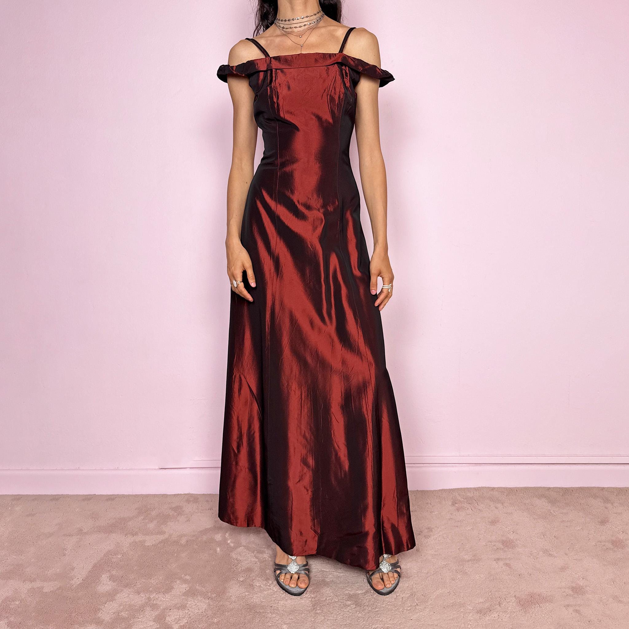 Vintage 2000s statement evening gown in rich burgundy iridescent fabric with a sculpted off shoulder neckline and delicate straps. Elegant body-skimming silhouette with full length maxi cut, subtle flare hem and back zip closure. Dramatic old Hollywood energy, perfect for formal events, editorials or modern occasionwear. Non-stretch fabric. Excellent vintage condition.