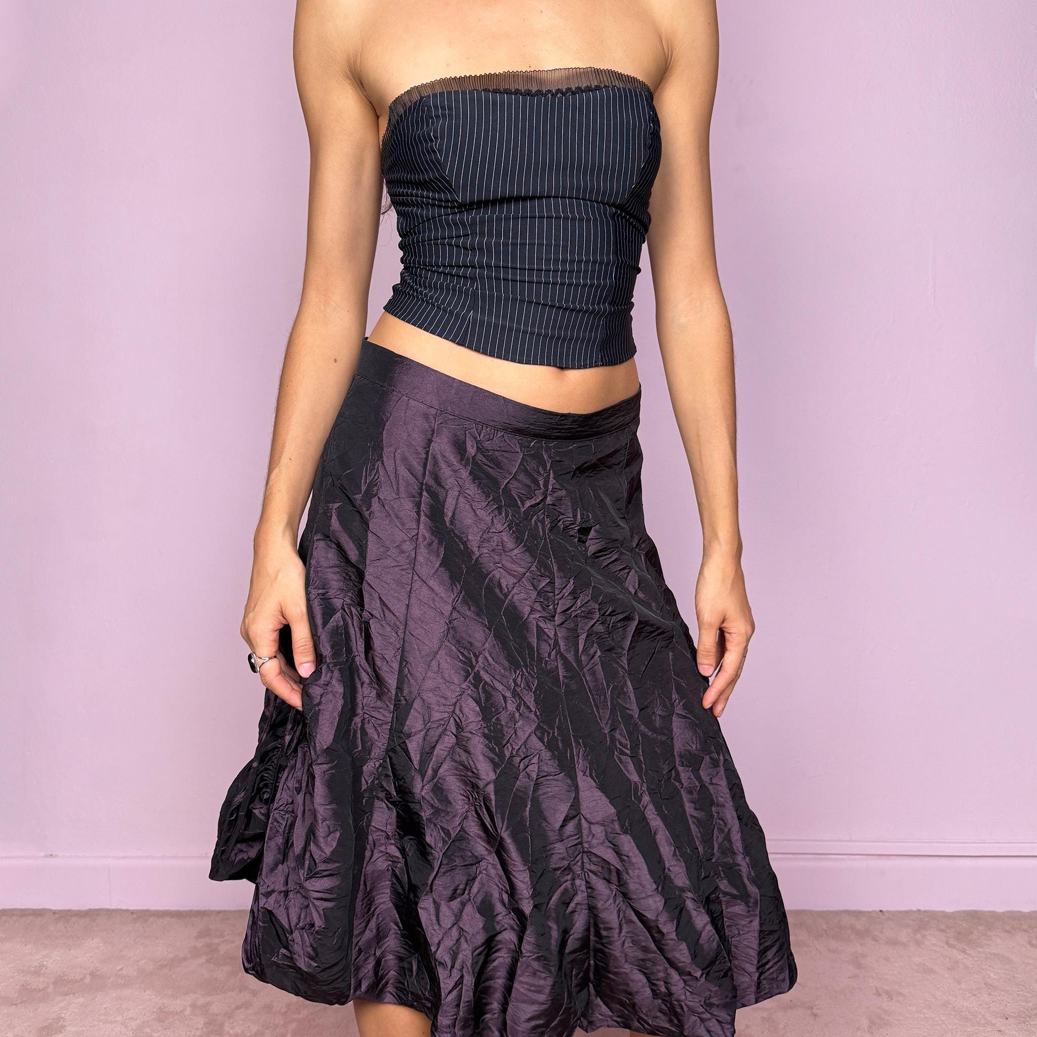 This vintage 90s dark purple iridescent midi skirt features a bubble balloon hem and adjustable ruched drawstrings at the sides, allowing for a sculptural, futuristic silhouette. Crafted from textured crinkle fabric with a back zipper closure and no stretch. A rare statement piece merging cyber, dystopian, and techwear aesthetics with Harajuku grunge edge. Can be worn high-waisted for size XL or mid-rise for size L. Excellent vintage condition.