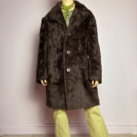 The Vintage 90s Faux Fur Brown Coat is a plush and cozy statement piece with a classic silhouette. Featuring deep chocolate brown faux fur fabric, a wide notched collar, bold contrasting buttons and pockets. Perfect for vintage streetwear, or cozy casual winter looks. adult world shop