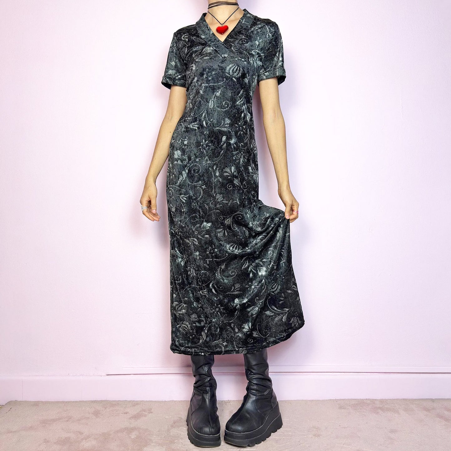 The Vintage 90s Gray Velvet Midi Dress is a moody and elegant 90s piece made from soft, stretchy dark gray velvet with a baroque-style printed pattern. Features a flattering V-neckline, short sleeves, and a sleek longline silhouette. The velvety fabric gives it a luxurious feel while staying comfy. Perfect for witchy aesthetics, gothic romance, or vintage night-out looks.