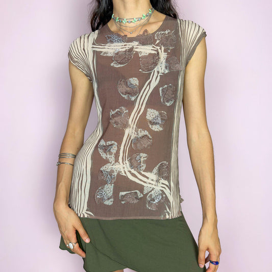 This vintage 1990s semi-sheer crinkled pleated sleeveless top features an abstract vine and lace motif in soft taupe brown and beige. An ethereal avant-garde piece with architectural flow and botanical texture—rare and striking, ideal for summer artsy events. Made of polyester. Excellent vintage condition.