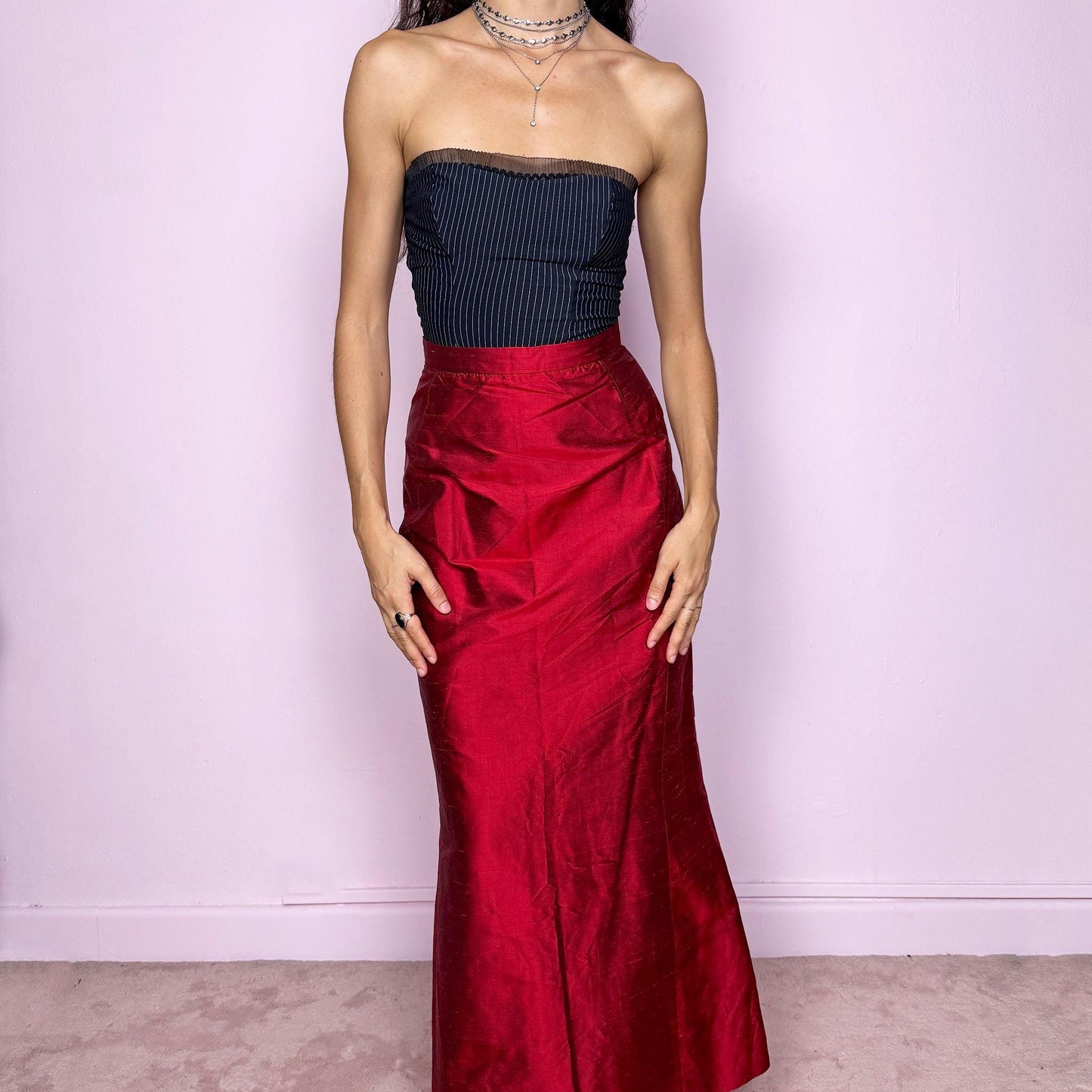 This vintage 90s red shiny maxi skirt features a sculpted mermaid silhouette with a high-waisted fit and back zipper closure. Made in France from non-stretch polyester, it radiates diva allure with a formal, romantic tone, perfect for gala nights, prom, or elegant evening events. A stunning statement piece of timeless sophistication. Made from non-stretch polyester. Great vintage condition.