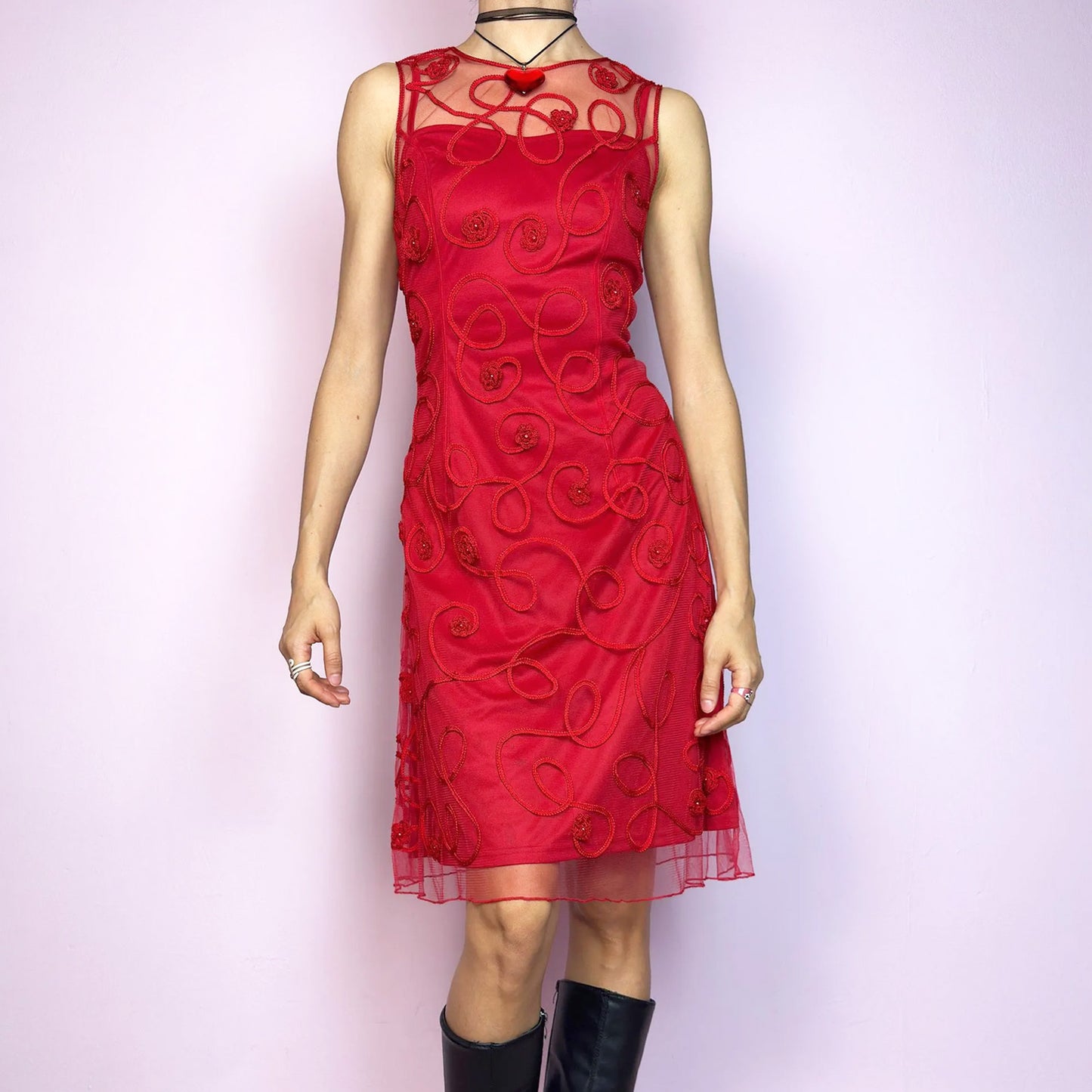 The Vintage 90s Red Mesh Cocktail Dress is a striking sheer-layered piece featuring a sculpted fit with a delicate mesh overlay. Adorned with spiral embroidery and floral appliqué details, this sleeveless dress has a sheer upper neckline for added drama. It’s fully lined and fastens with a back zipper closure. A bold romantic look, ideal for date nights, special events and Valentine’s-inspired outfits. Great vintage condition.