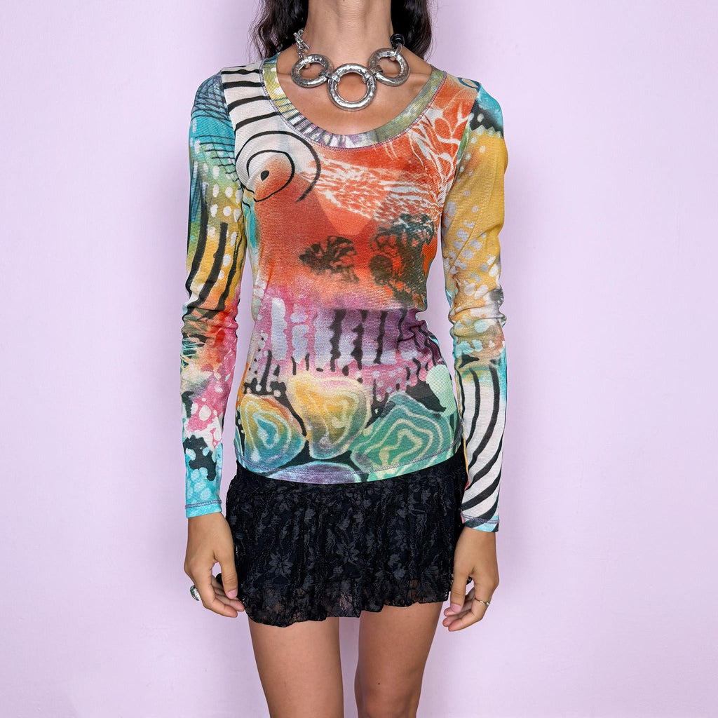 Vintage 2000s long-sleeve mesh top featuring a vibrant abstract graphic print mixing turquoise, orange, yellow, pink, and green with contrasting organic, striped, and painterly motifs. Designed with a fitted silhouette, scoop neckline, and semi-sheer lightweight mesh construction. Stretchy fabric creates a close, second-skin fit. A strong maximalist Y2K piece with an art-print feel. Made in France by a French brand from 100% polyester. Excellent vintage condition.
