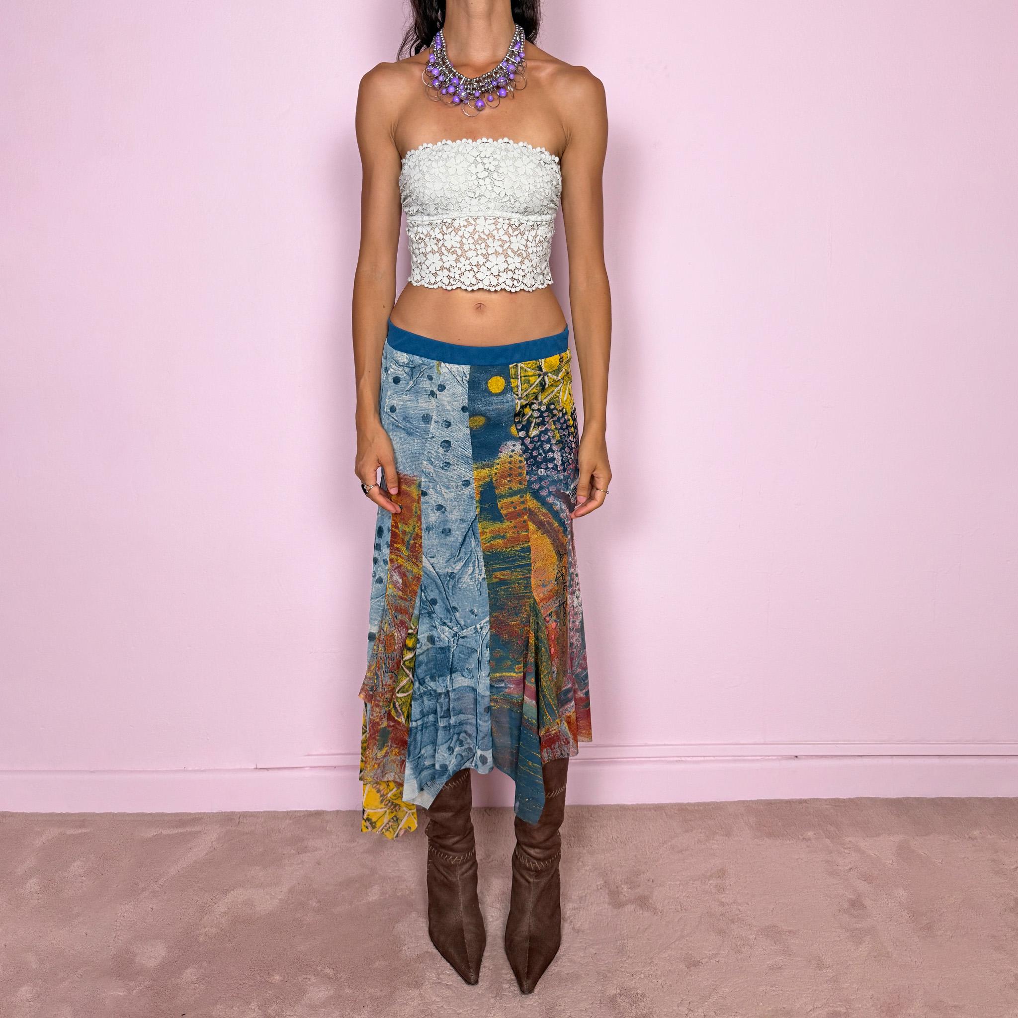 Vintage 2000s asymmetric mesh midi skirt crafted from lightweight, semi-sheer mesh with a fluid patchwork construction combining abstract graphic prints, painterly textures, and contrasting color panels in washed blue, yellow, orange, and earthy tones. Finished with an irregular handkerchief-style hem and layered inserts for a deconstructed, maximalist wearable-art Y2K silhouette.