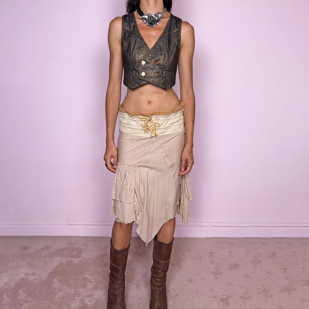Vintage 2000s midi skirt, crafted from 100% cotton in a soft beige tone with a romantic low-rise silhouette and adjustable tie-front waist. Designed with a wide structured waistband, lace-up front detail, crochet-style trim along the top edge, and an asymmetric layered skirt with panel construction. A delicate bohemian Y2K piece with a deconstructed fairy summer feel. Very good vintage condition, with one small faint discoloured mark on the waistband, as shown in the last picture.