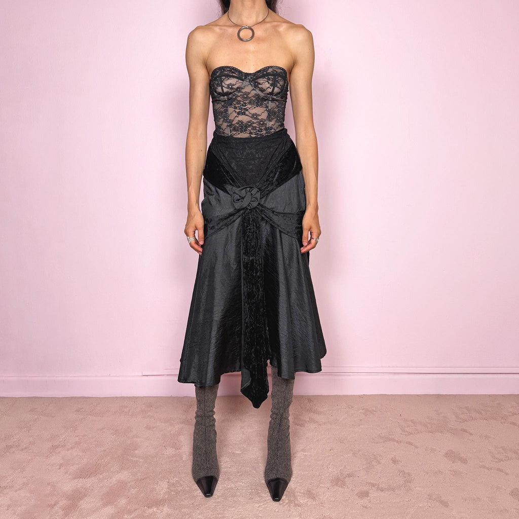 Vintage 2000s rare statement black avant-garde midi skirt made in France from 100% viscose. High-waisted fit with back zip closure, elasticated waist, dramatic flared silhouette, asymmetric draped construction, and velvet-textured front details. Dark, elegant, and sculptural, ideal for a formal party with a witchy twist. Can be worn high waisted for size S and XS. Excellent vintage condition.