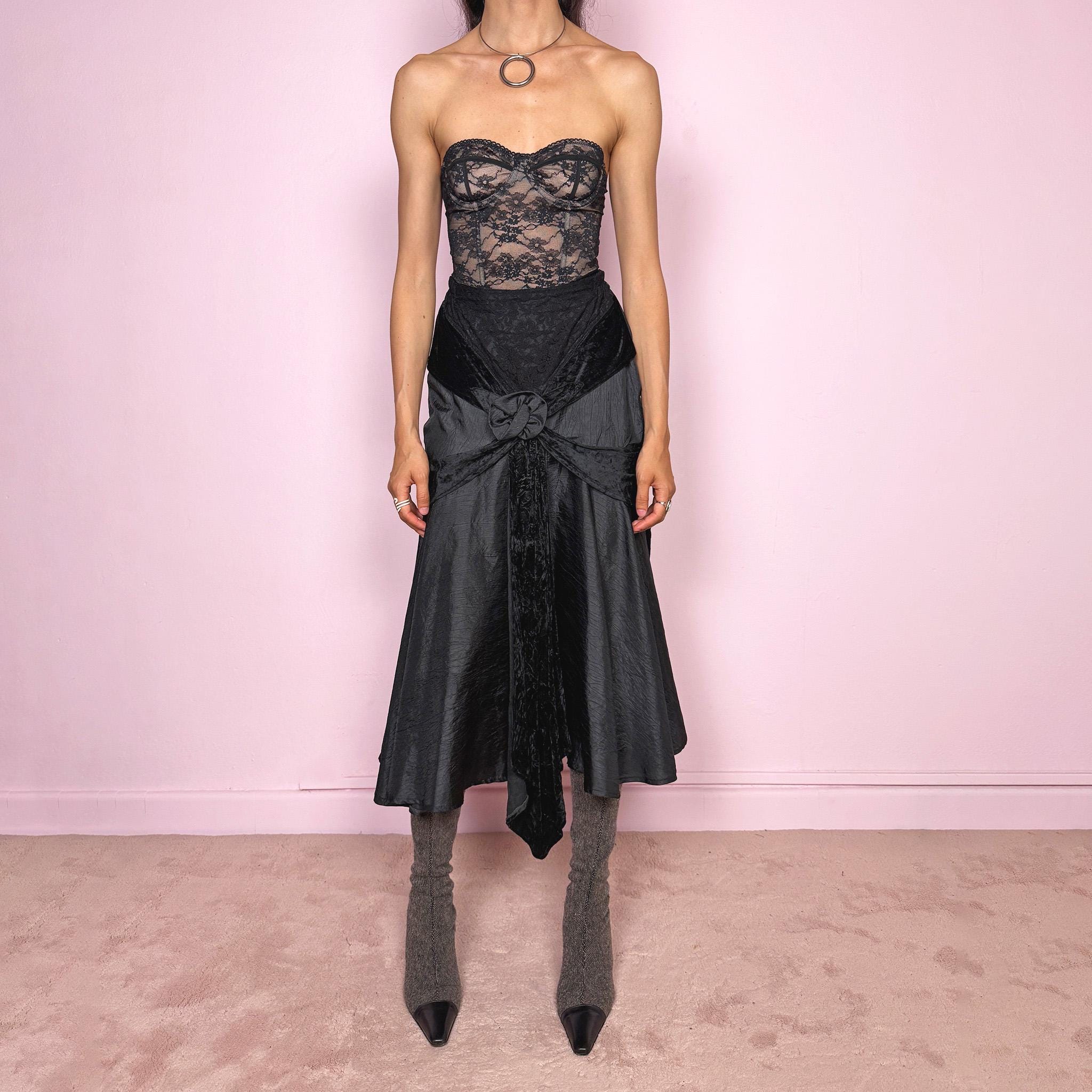 Vintage 2000s rare statement black avant-garde midi skirt made in France from 100% viscose. High-waisted fit with back zip closure, elasticated waist, dramatic flared silhouette, asymmetric draped construction, and velvet-textured front details. Dark, elegant, and sculptural, ideal for a formal party with a witchy twist. Can be worn high waisted for size S and XS. Excellent vintage condition.