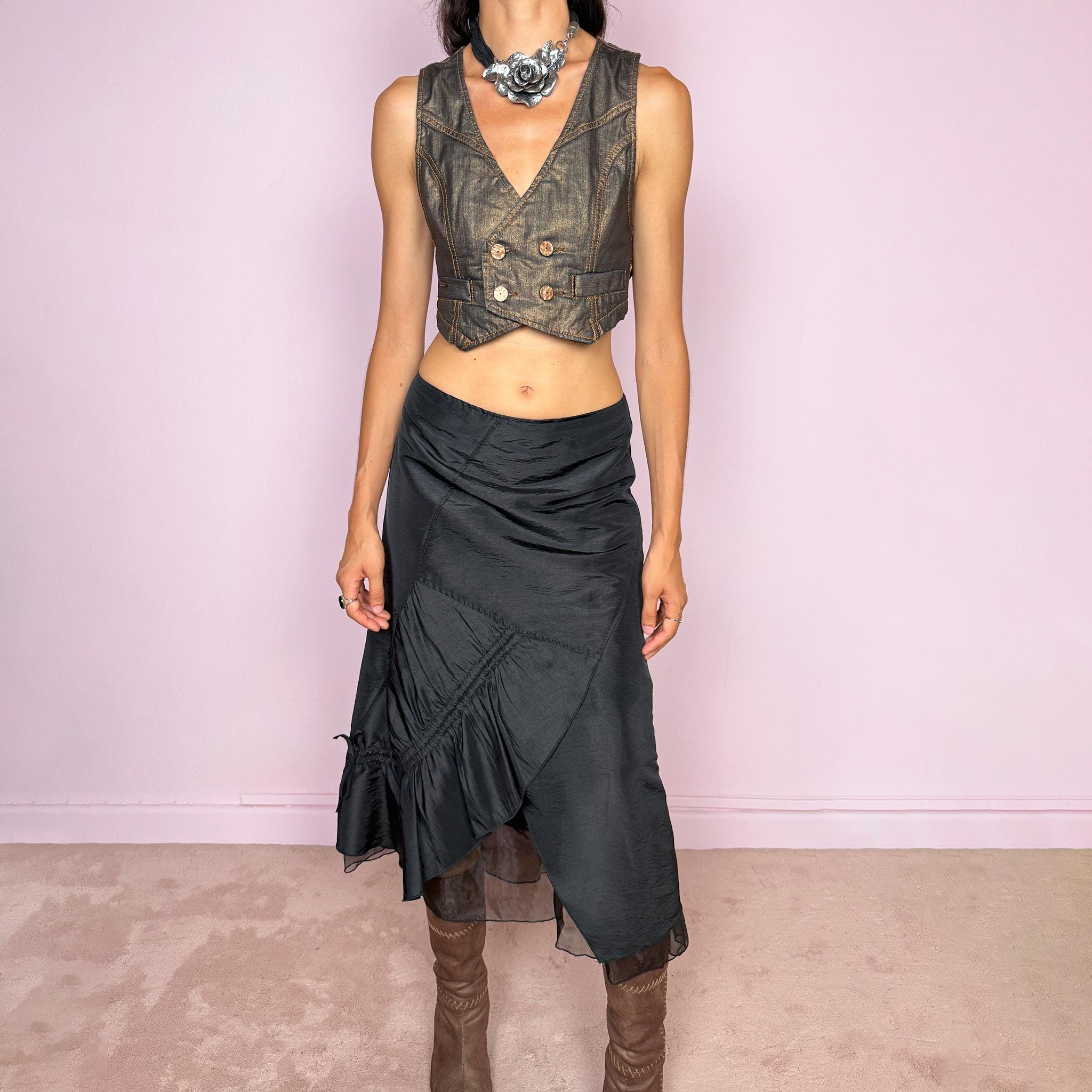 Vintage 2000s black midi skirt featuring an asymmetric deconstructed silhouette with diagonal paneling, gathered ruching, a sculptural draped insert, and a sheer black underlayer. Elegant dark avant-garde style, perfect for formal outfits. Non-stretch fabric with a back zip closure. Can be worn high-waisted for size M or slightly lower on the waist for sizes S and XS. Composition label is missing, so the exact fabric is unknown. From a French brand. Excellent vintage condition.