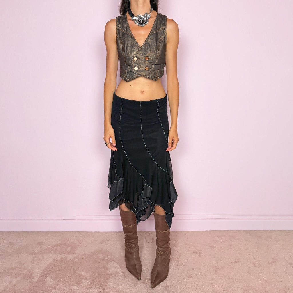 Vintage 2000s black mesh midi skirt, featuring a fluid asymmetric layered construction with sheer panels and an irregular handkerchief hem. Finished with contrasting metallic thread along the curved seams and edges, creating a subtle shimmering effect throughout. Stretchy with an elasticated waist, ideal for statement evening looks. Can be worn mid- to low-rise for size S. Made in Italy from 95% viscose. Excellent vintage condition.