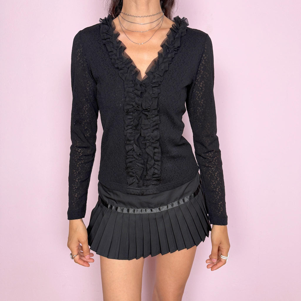 Vintage 2000s black stretch lace mesh top, designed with a fitted silhouette, sheer floral lace texture, long sleeves, and dramatic ruffle detailing through the deep V neckline. The layered mesh ruffles add a dark romantic, gothic, and feminine feel ideal for evening outfits. Made from 100% polyamide. Excellent vintage condition.