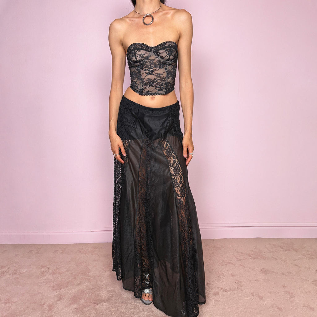Vintage 90s black gothic maxi skirt with an elasticated waist and dramatic floor-length silhouette. Features sheer lace panels, semi-transparent mesh sections, and layered fabric construction for a dark romantic lingerie-inspired finish. Can be worn high waisted for M or lower rise for S. Made from 100% polyester. Great vintage condition.