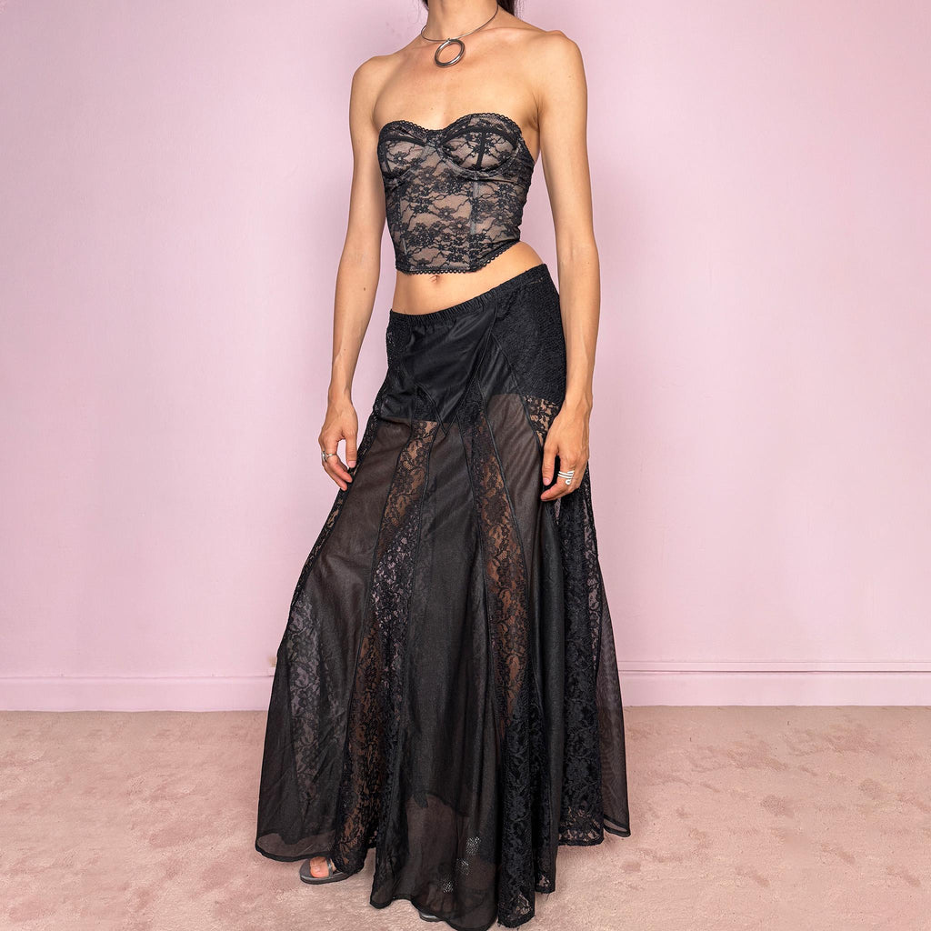Vintage 90s black gothic maxi skirt with an elasticated waist and dramatic floor-length silhouette. Features sheer lace panels, semi-transparent mesh sections, and layered fabric construction for a dark romantic lingerie-inspired finish. Can be worn high waisted for M or lower rise for S. Made from 100% polyester. Great vintage condition.