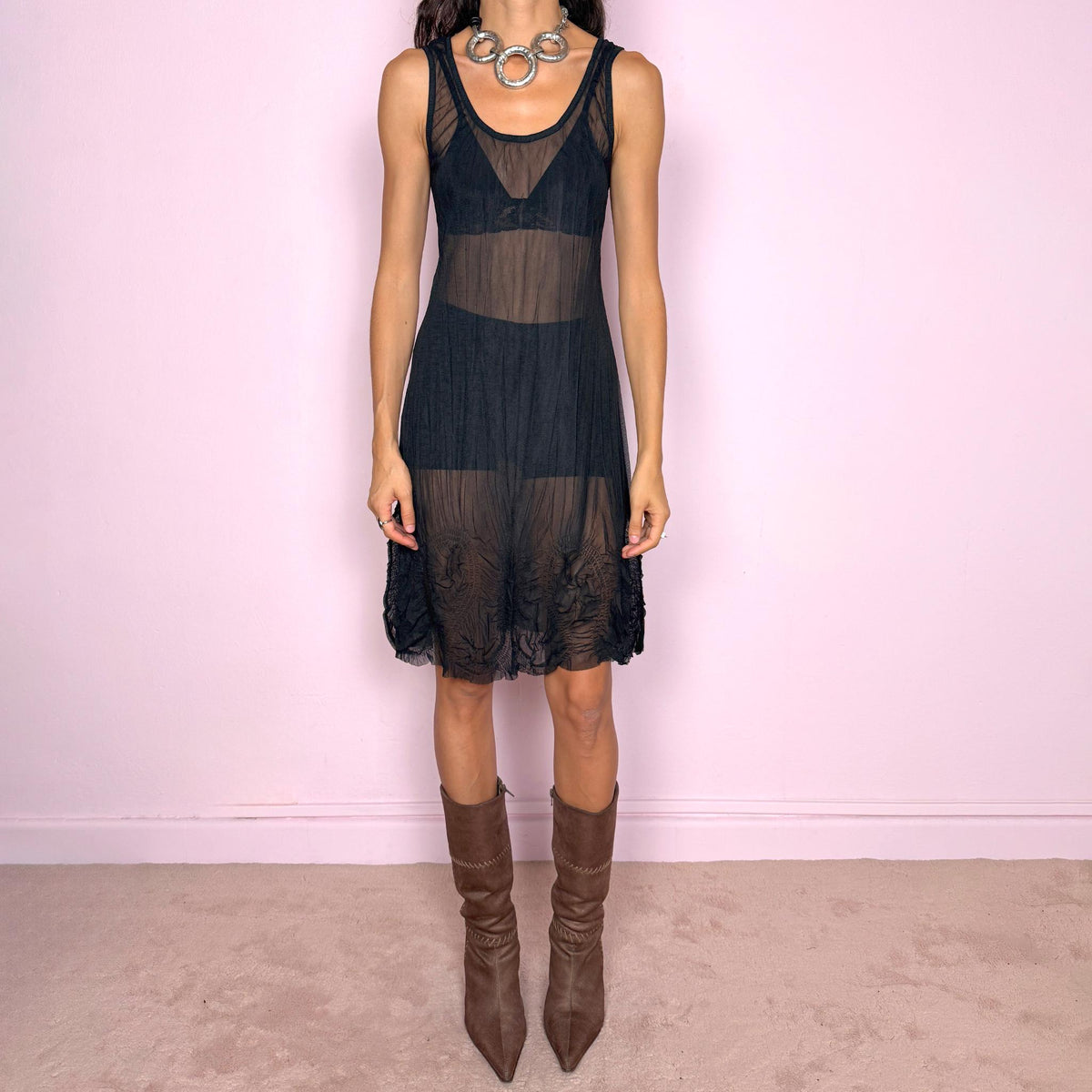 Vintage 2000s black sheer midi dress featuring a sleeveless stretchy silhouette with a scoop neckline and semi-sheer mesh construction. The lower skirt is finished with irregular heat-set pleated and crinkled detailing, creating a textured, fluid hem. From a French brand, made in France from 100% polyester. Excellent vintage condition.