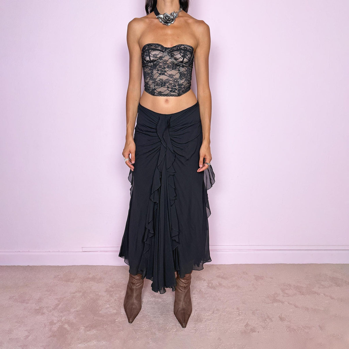 Vintage 2000s black silk midi skirt featuring soft ruching through the hips, cascading ruffle detailing down the front and sides, and a fluid flared hem for dramatic movement. Back zip closure and non-stretch. The layered silk construction and sculptural draping are ideal for elevated evening styling. Can be worn mid-rise for size M or lower on the waist for size S. Made in Italy by an Italian brand from 100% silk with a 100% polyester lining. Excellent vintage condition.