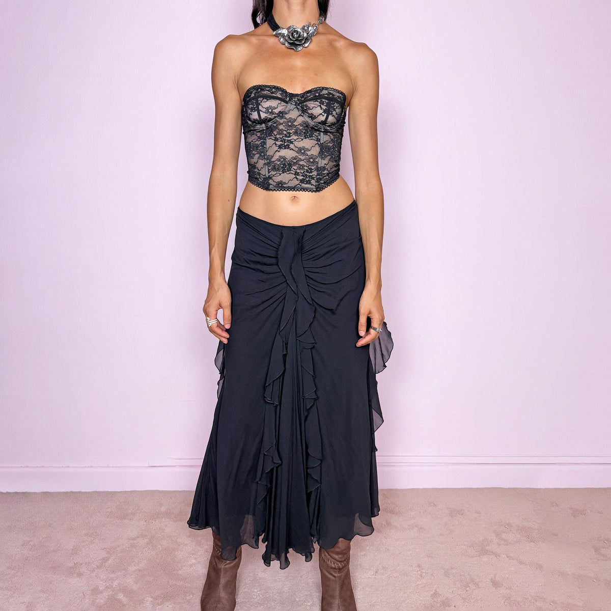 Vintage 2000s black silk midi skirt featuring soft ruching through the hips, cascading ruffle detailing down the front and sides, and a fluid flared hem for dramatic movement. Back zip closure and non-stretch. The layered silk construction and sculptural draping are ideal for elevated evening styling. Can be worn mid-rise for size M or lower on the waist for size S. Made in Italy by an Italian brand from 100% silk with a 100% polyester lining. Excellent vintage condition.