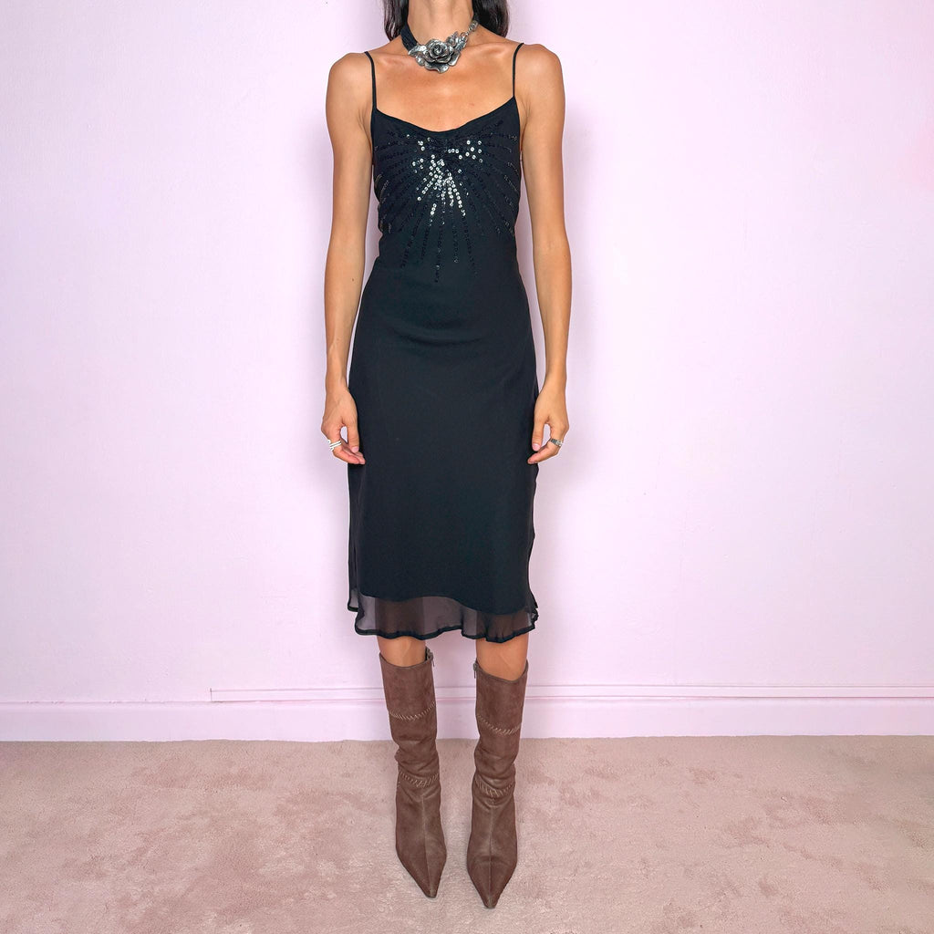 Vintage 2000s black silk midi dress crafted from 100% silk. Featuring a fluid slip-style silhouette with adjustable spaghetti straps and black sequin embellishment across the bust. Lightweight and non-stretch, with a semi-sheer outer layer and black lining underneath. Perfect for minimal evening styling. Excellent vintage condition.