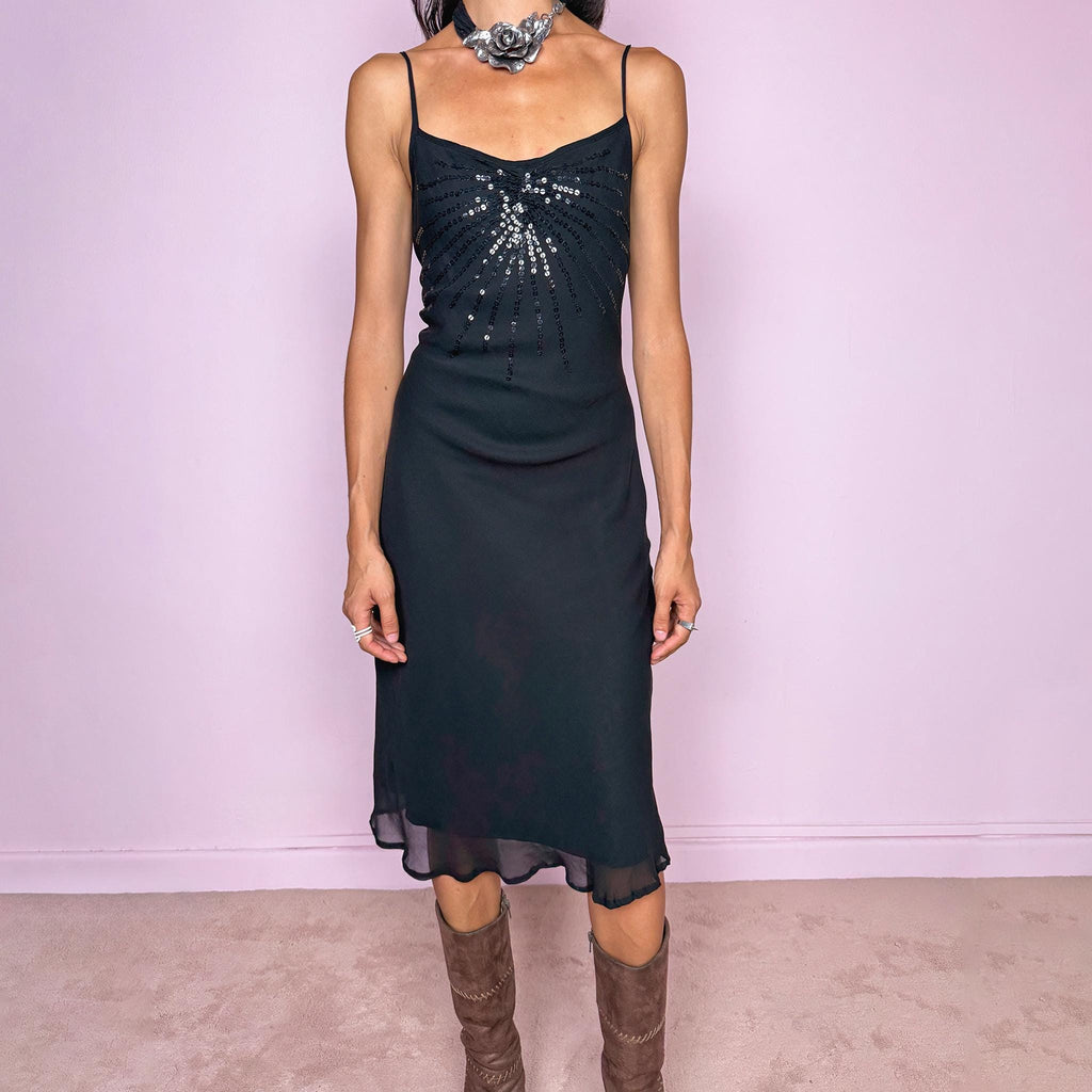 Vintage 2000s black silk midi dress crafted from 100% silk. Featuring a fluid slip-style silhouette with adjustable spaghetti straps and black sequin embellishment across the bust. Lightweight and non-stretch, with a semi-sheer outer layer and black lining underneath. Perfect for minimal evening styling. Excellent vintage condition.
