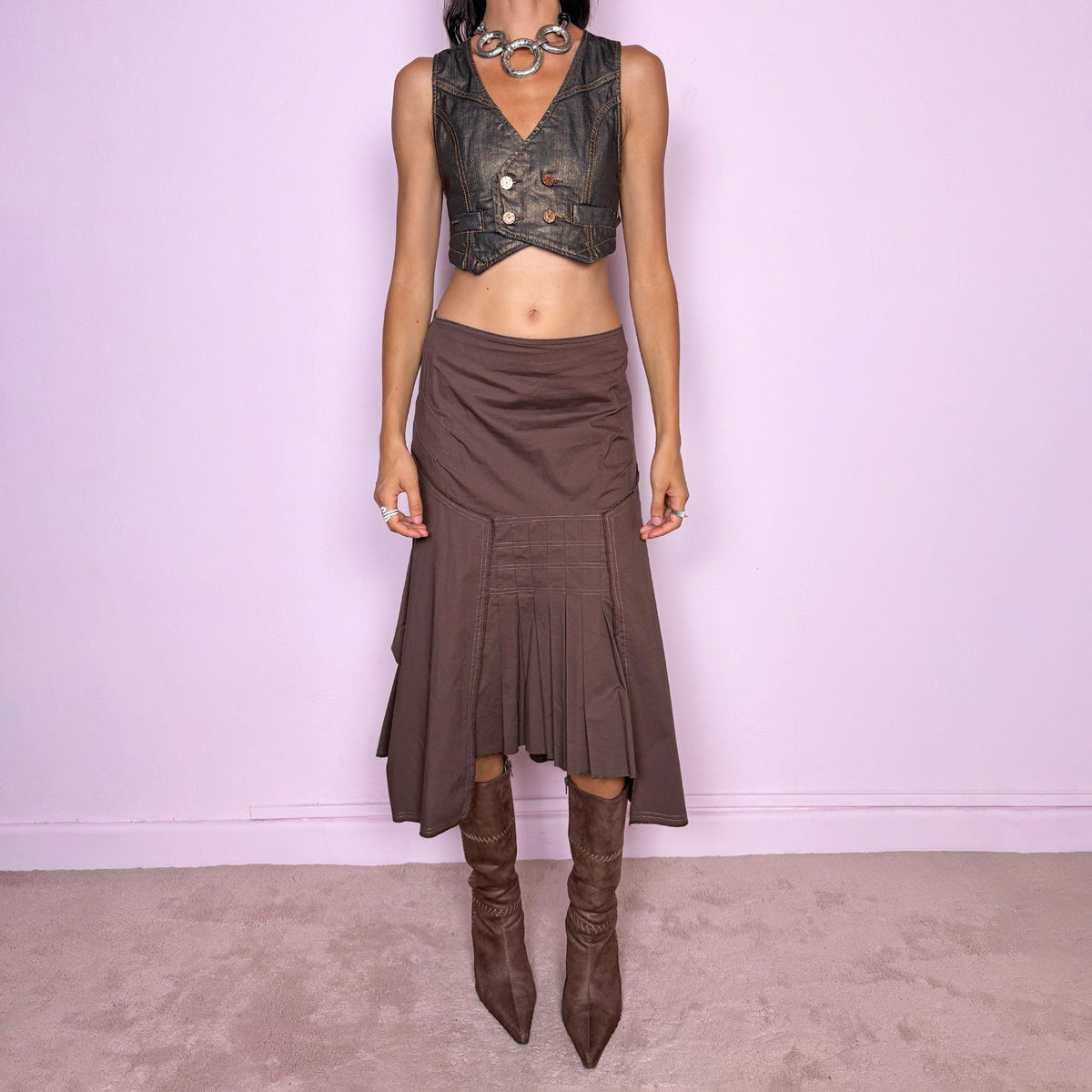 Vintage 2000s brown asymmetric midi skirt featuring a draped construction, contrast topstitching, and a sculptural asymmetric hem with pleated panel detailing at the front. Finished with a back zip closure. The earthy brown tone and deconstructed tailoring give it a distinctly avant-garde aesthetic. Can be worn mid-rise for size S or lower on the waist for size XS. From a French brand, made in France from a slightly stretchy 96% cotton and 4% elastane blend. Excellent vintage condition.