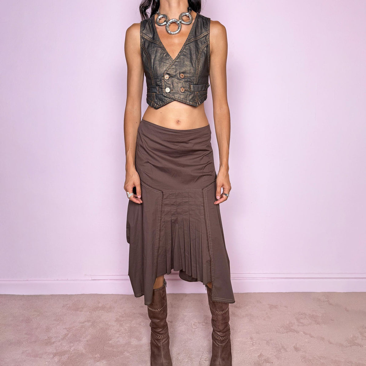 Vintage 2000s brown asymmetric midi skirt featuring a draped construction, contrast topstitching, and a sculptural asymmetric hem with pleated panel detailing at the front. Finished with a back zip closure. The earthy brown tone and deconstructed tailoring give it a distinctly avant-garde aesthetic. Can be worn mid-rise for size S or lower on the waist for size XS. From a French brand, made in France from a slightly stretchy 96% cotton and 4% elastane blend. Excellent vintage condition.