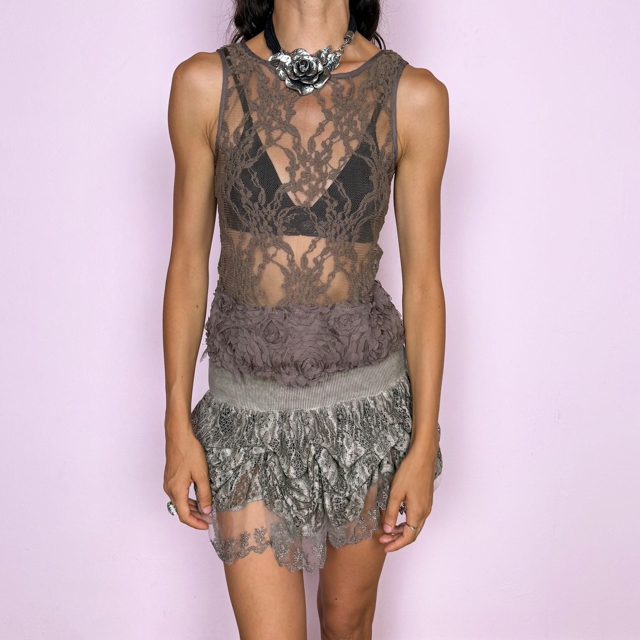 Vintage 2000s sleeveless taupe brown lace top featuring a fitted, stretchy, semi-sheer construction with ornate floral lace throughout. Designed with a round neckline and finished with a dramatic textured hem of layered floral appliqués for added dimension. Features an elegant, delicate, romantic, and ethereal silhouette. Brand, size, and composition labels are missing. Excellent vintage condition.