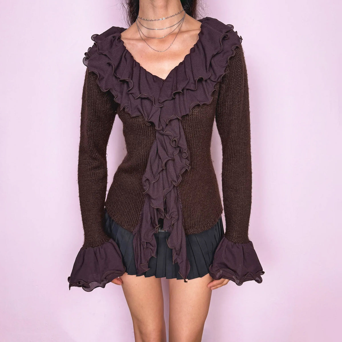 Vintage 2000s dark brown cardigan made from a stretchy knit, featuring dramatic layered mesh ruffles, delicate front buttons, and flared ruffle cuffs. A feminine, dark statement piece. From a French brand. Made from 35% wool, 10% cashmere, and 55% acrylic. Great vintage condition.