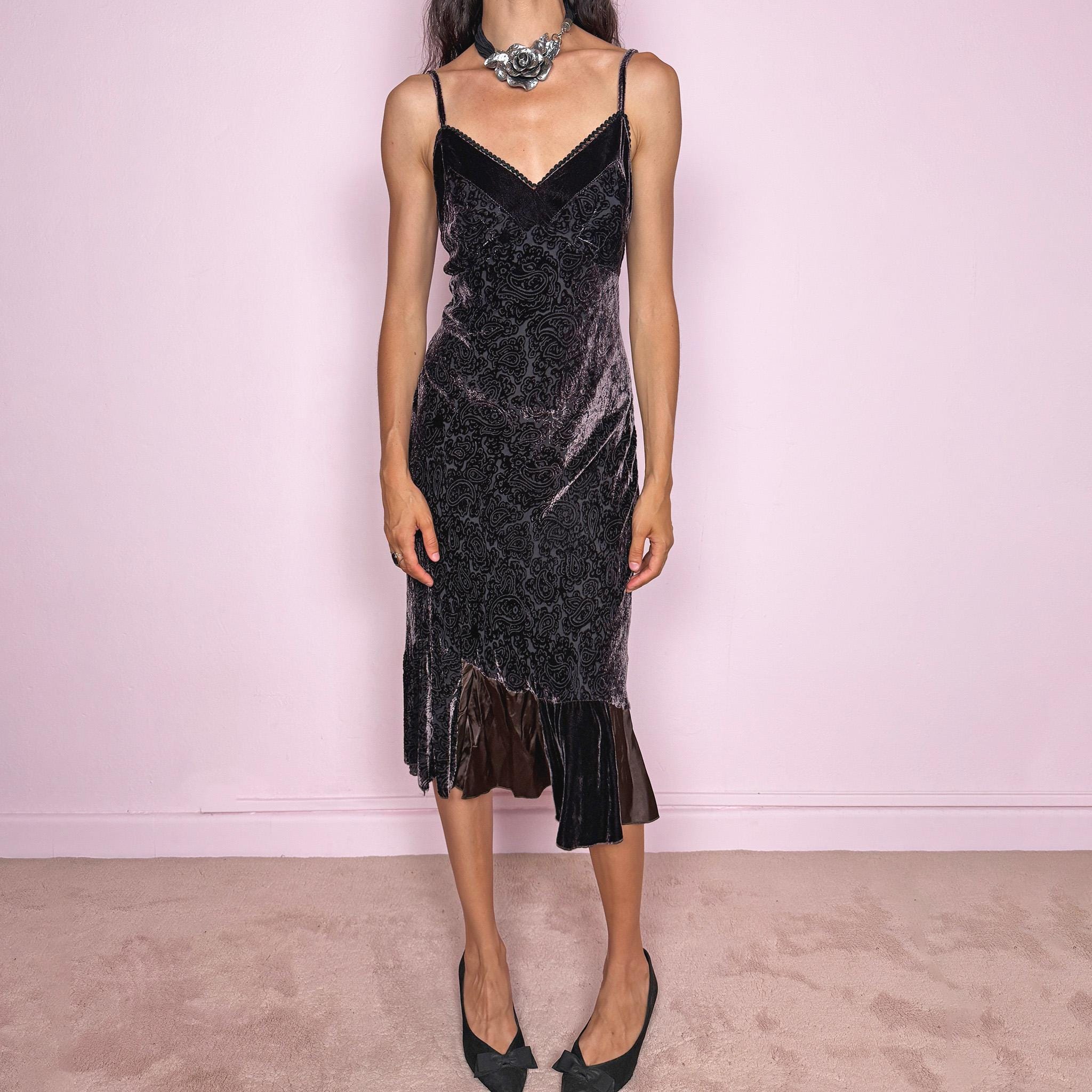 Vintage 2000s brown velvet devoré slip midi dress with burnout paisley texture, adjustable straps, V neckline, fluid drape, and asymmetric ruffled hem. Subtle sheen gives it an elegant dark romantic feel, ideal for mysterious night rendezvous. Made in France from 70% viscose and 30% silk blend. Excellent vintage condition.