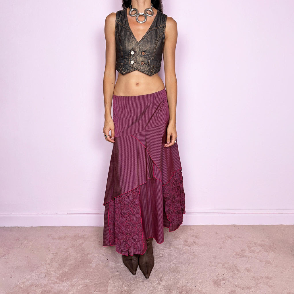 Vintage 2000s burgundy asymmetric maxi skirt featuring a side zip closure and an irregular layered construction combining fine pinstripe panels with ruched and gathered textured sections. Can be worn high-waisted for size L or lower on the waist for sizes M–S. From a French brand, made from 100% non-stretch polyester. Excellent vintage condition.