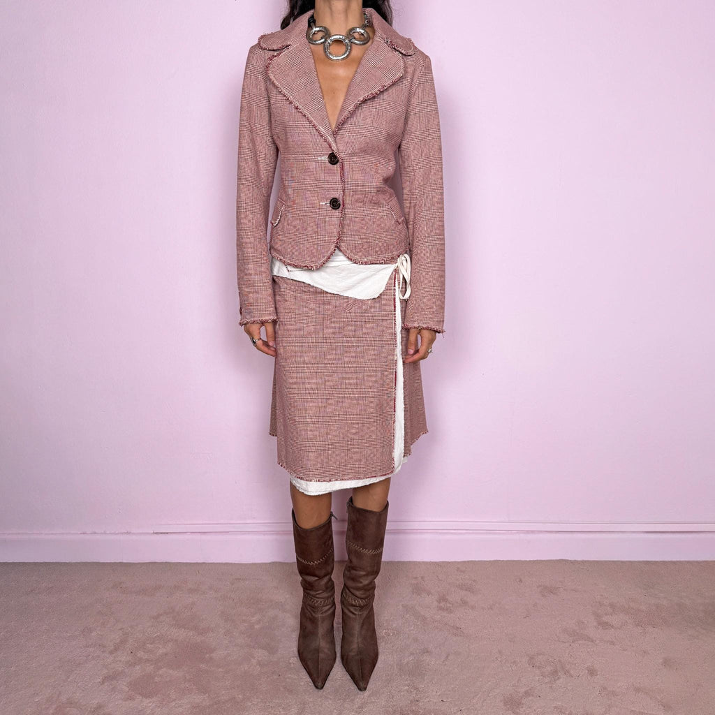 Vintage 2000s burgundy-red and cream two-piece skirt suit. The set includes a fitted blazer with a glen plaid / Prince of Wales check pattern, raw-edge trim, notched lapels, and a two-button front closure. Paired with a matching wrap-style midi skirt featuring layered cream lining, a side button closure, and an adjustable tie. The contrasting construction and unfinished edges create a relaxed, deconstructed feel while maintaining a tailored silhouette.