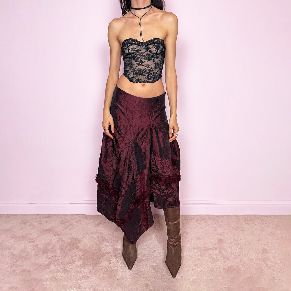 Vintage 2000s burgundy iridescent midi skirt with an avant-garde experimental feel. Features a crinkle texture, asymmetric hem, and sculptural draped panels with rosette appliqué details. Voluminous, artistic silhouette with a back zip closure and no stretch. Can be worn high-waisted for size M or lower on the waist for sizes XS and S. Made from polyester. Excellent vintage condition.