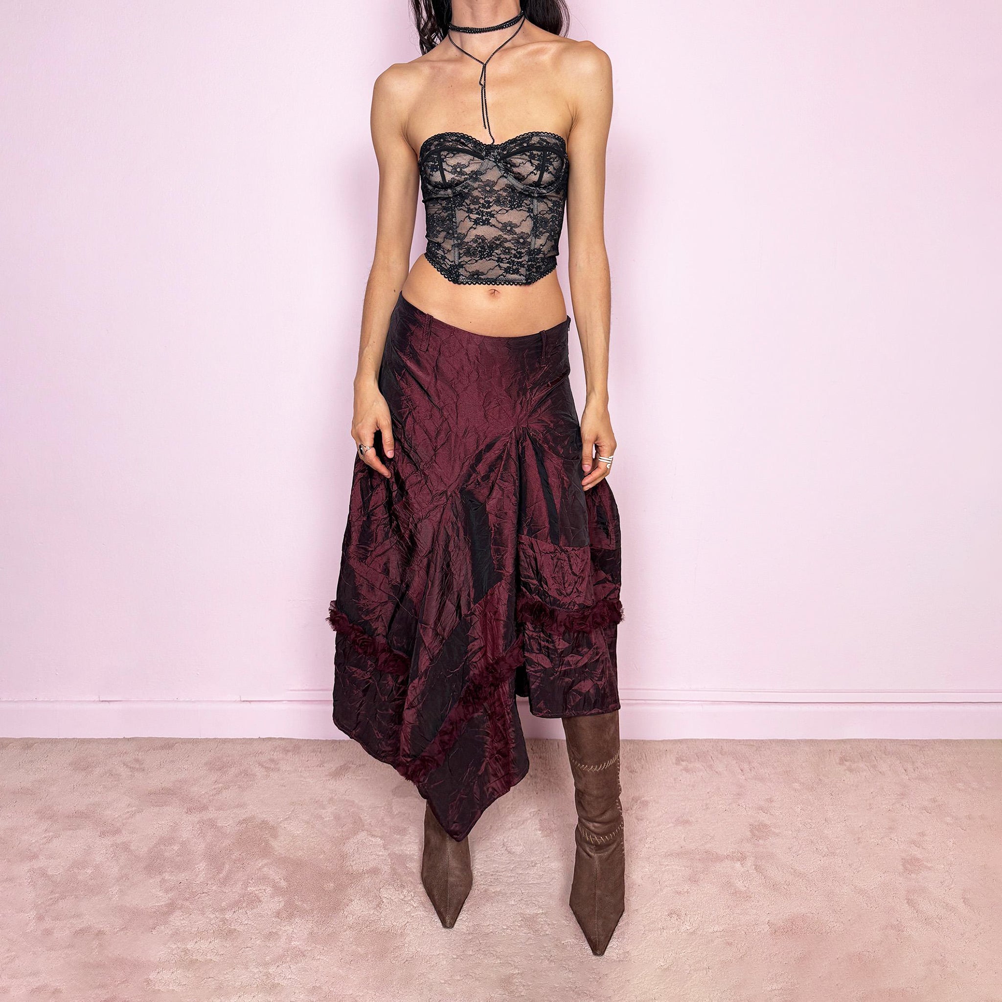 Vintage 2000s burgundy iridescent midi skirt with an avant-garde experimental feel. Features a crinkle texture, asymmetric hem, and sculptural draped panels with rosette appliqué details. Voluminous, artistic silhouette with a back zip closure and no stretch. Can be worn high-waisted for size M or lower on the waist for sizes XS and S. Made from polyester. Excellent vintage condition.
